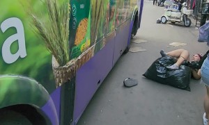 Woman Walks Into Bus Lane Without Looking