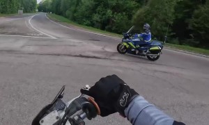 Motorcycle Driver Cuts Across Roundabout Just as Police Pull Up