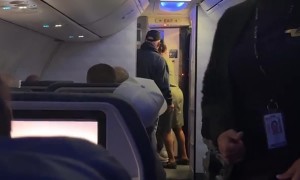 Man Attempts to Force Himself Off Plane