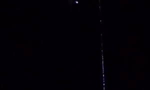 Bright Object Crosses Satellite Path In Night Sky