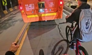 Bikers Follow Behind Bus With Tied Ropes