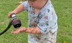 Say “Cheese” — Sprays Mommy With Hose