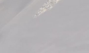 Snowboarding on Top of a Slab Rock While My Dog Waits for Me