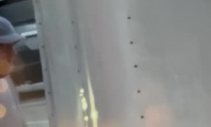 Wind Blows Loose Trailer in Parked Car