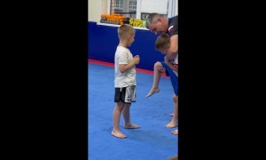 Two Boys Learning How to Properly Kick
