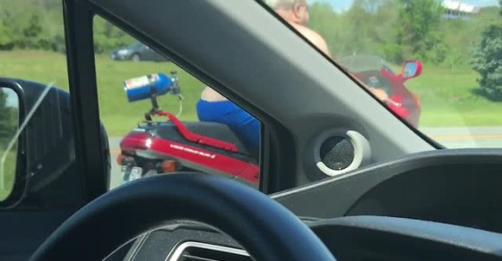 Shirtless Man Moseys Down Highway on Motorcycle - Sharedots
