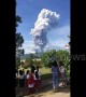 Schoolchildren watch as volcano erupts on quake-hit Indonesia island