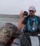 Playful seal tries to climb aboard kayak