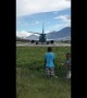 Cheeky boys knocked over by wind from jet plane