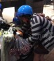 Old lady rides away with dozens of bags of fruit on her moped