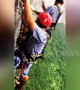 Daredevil tourists climb on a vertical cliff in central China