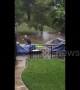 Resident kayaks through waterlogged street to rescue neighbor\'s boat as severe flooding hits Central Texas