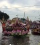 Thais mark the end of Buddhist Lent by throwing lotus flowers onto boats