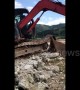Skilled digger driver uses arm to fix broken machine