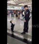Cute boy just wants a hug from airport security guard