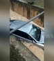 Car washed away after skidding into a storm drain flooded by Malaysian monsoon