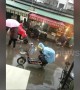 Small boy keeps his mum\'s bike seat dry in the rain with his own body