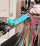 Hairdresser uses paint rollers to give clients\' hair a rainbow hue