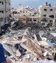 Palestinians inspect ruins of Hamas TV station after Israeli air strike on Gaza