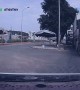 Man Crashes Motorcycle and Narrowly Escapes Moving Truck