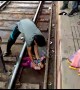 Moment miracle baby emerges unscathed after falling onto tracks and under moving train