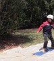 Australian science teacher gives daughter her first FlowRider experience using snowboard and shade cloth