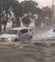 Cars drive through flooded streets of Pattaya, Thailand, as rainstorm hits
