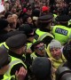Scuffles break out as police force their way into London climate protest
