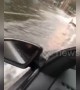 Cars drive on flooded roads as torrential rain lashes Sydney