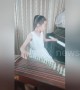 Talented Chinese girl plays piano and Chinese string instrument simultaneously