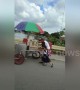 Tender moment schoolchildren help struggling elderly ice cream seller push cart up hill