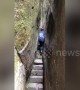Man walks through incredible narrow passage through Chinese mountains