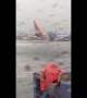 Plane stops at the very end of the runway during a landing in heavy rains