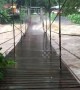 Flash floods batter suspension bridge in southern Thailand