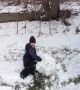 Boy Faces off with Big Snowball