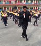 School pupils do choreographed shuffle dance with principal during break