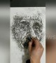 Art teacher uses cigarette ash to draw Albert Einstein