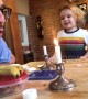 Dad entertains his kid by beatboxing with a candle flame