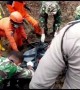 Search and rescue team evacuates landslide casualty in the wake of deadly Indonesia floods