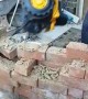 Worker Comically Demonstrates Demolition on Site
