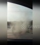 Terrified driver watches as dust devil approaches his car