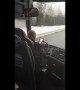 Bus driver types messages with both hands while driving on icy road