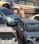 This car park is so packed that drivers have to push vehicles when they want to leave