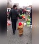 Smart dad uses strawberry to encourage son to follow him through market