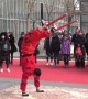 Performers impress visitors by somersaulting on stilts at Chinese temple fair