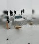 Family drifting car on frozen river end up breaking through thin ice