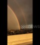 Spectacular double rainbow arcs over Los Angeles cityscape