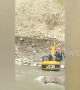 Local people transported by JCB across river to escape landslide in north India