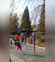 Old Chinese man swinging on horizontal bar knocks down girl walking by