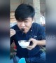 Instant regret? Man eats a squid ink sac, staining his lips and teeth black